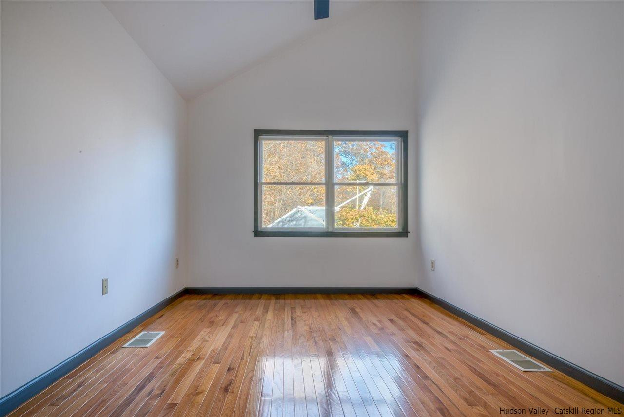 94 River Road Ulster Park, NY 12487 - Photo 24 of 31 an empty room with wooden floor and windows