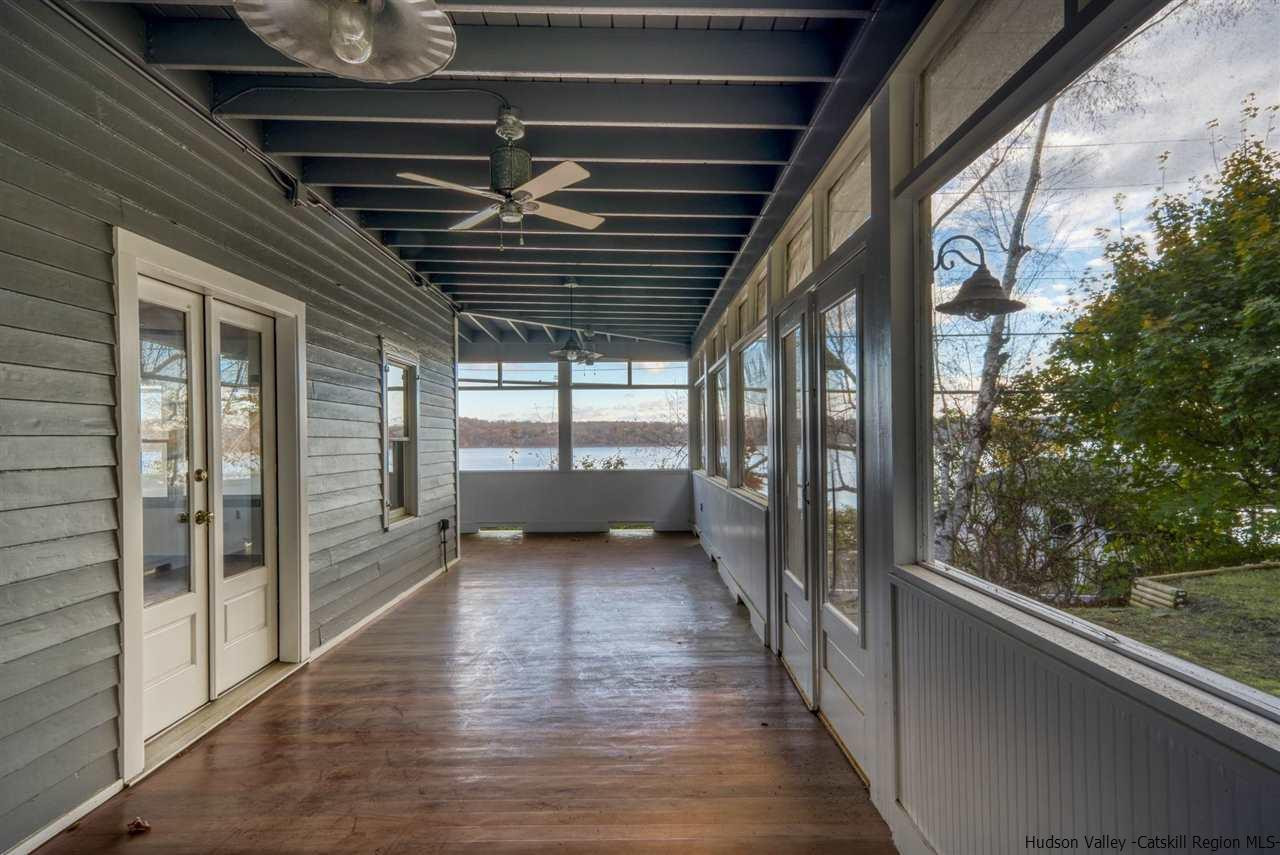 94 River Road Ulster Park, NY 12487 - Photo 28 of 31 a view of an empty room with wooden floor and a gate