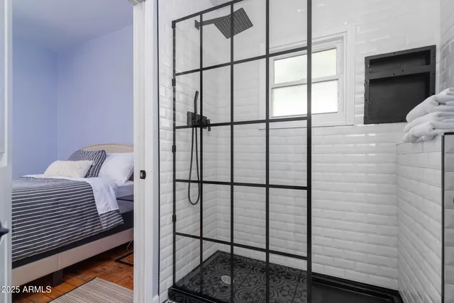 a bedroom with a bed and a flat screen tv