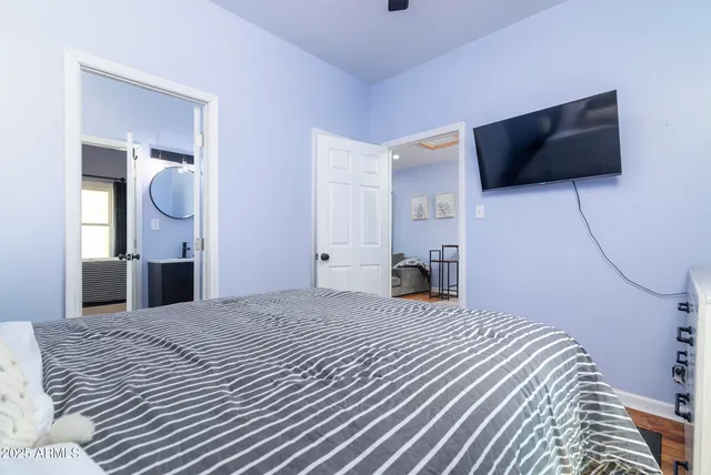 a bedroom with a large bed and a window