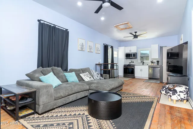 a living room with furniture and a flat screen tv
