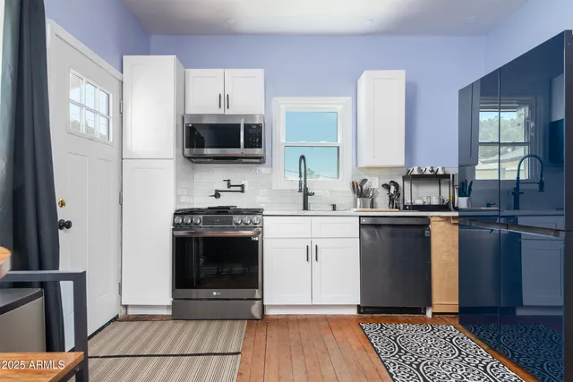 a kitchen with a sink stove and microwave