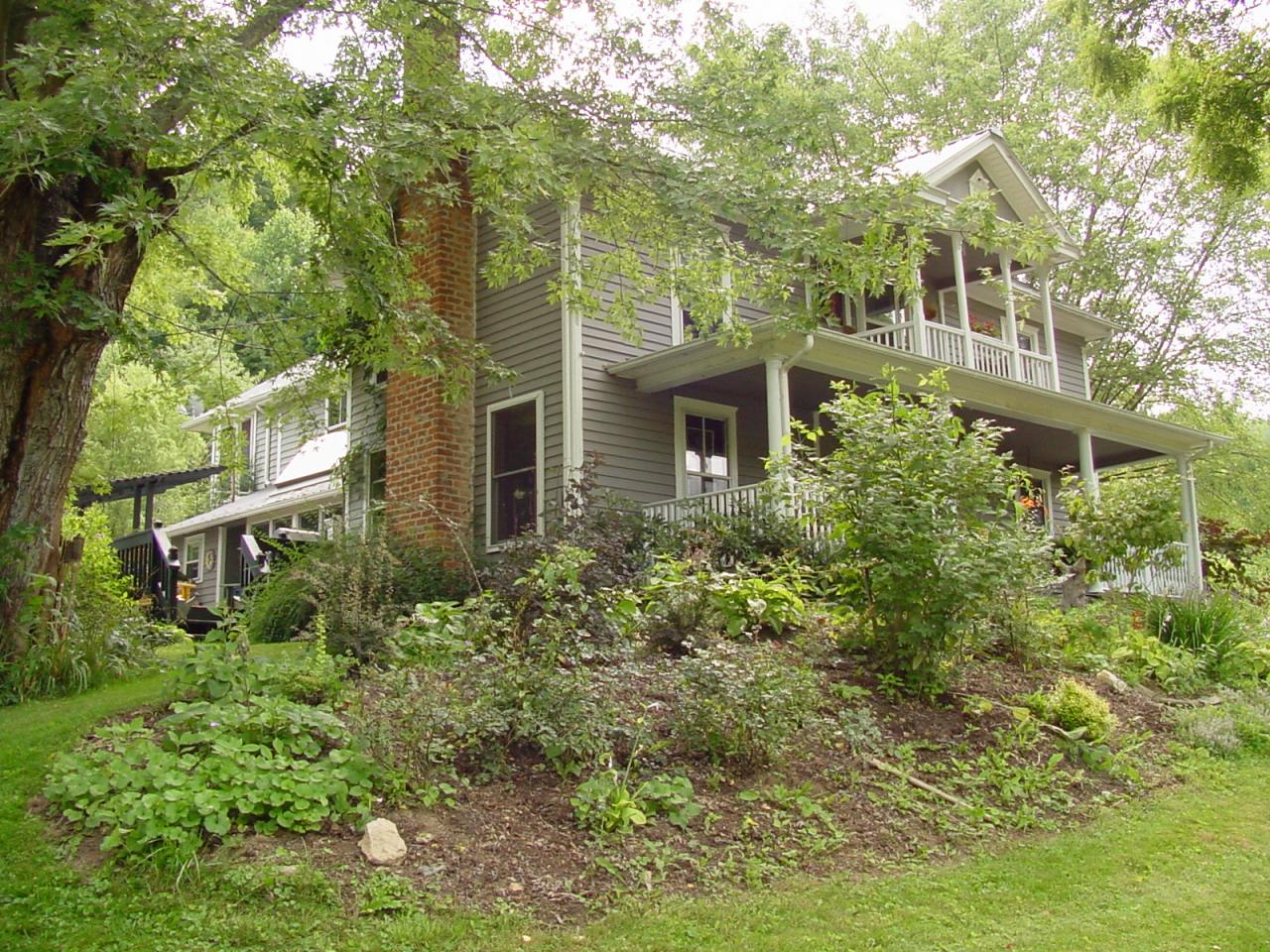 428 Sowers Mill Dam Road Northeast Riner, VA 24149 - Photo 2 of 31 a front view of a house with plants and trees