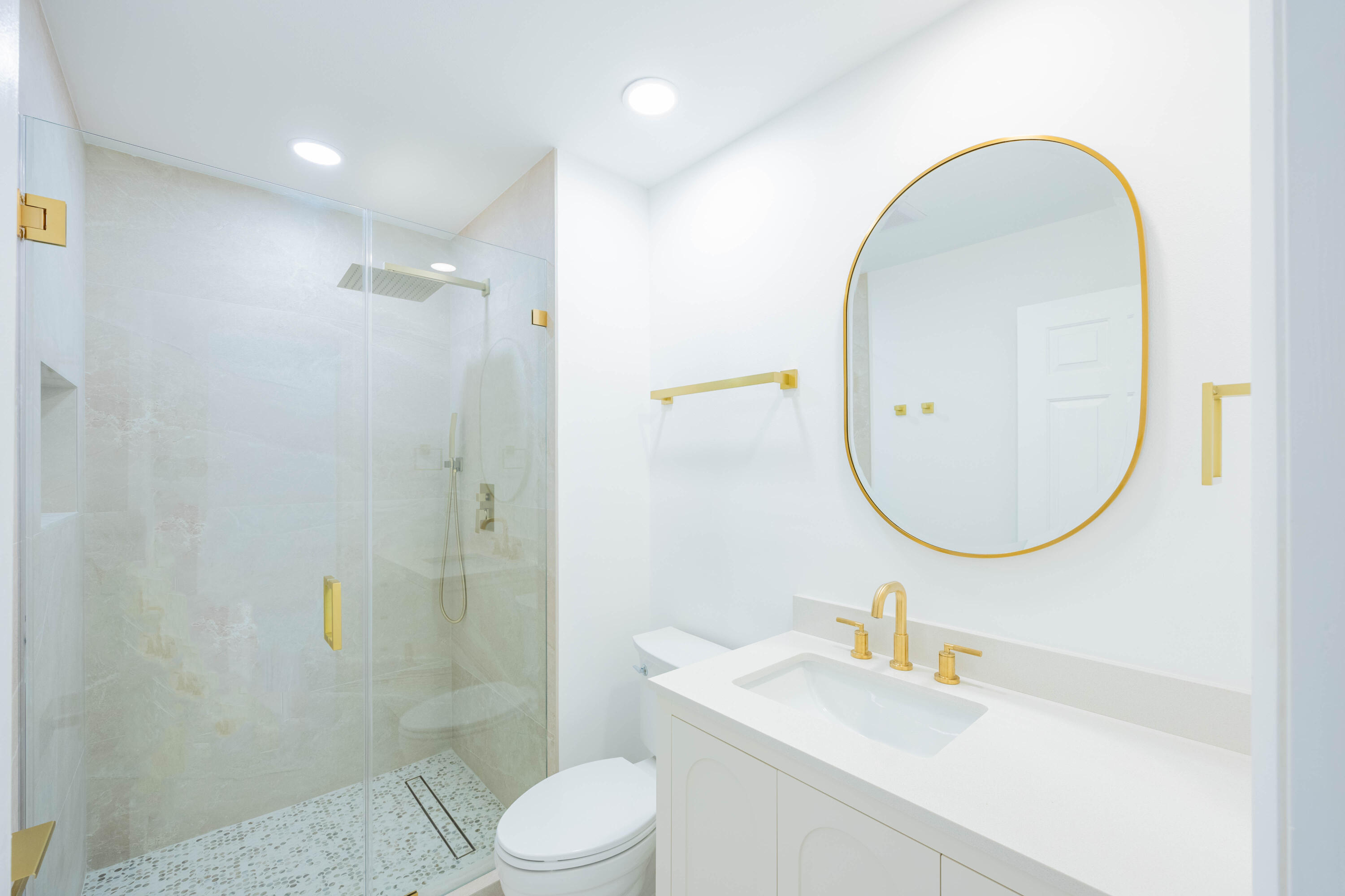 7520 La Paz Boulevard, Unit 104 Boca Raton, FL 33433 - Photo 35 of 56 a bathroom with a sink a toilet and a mirror