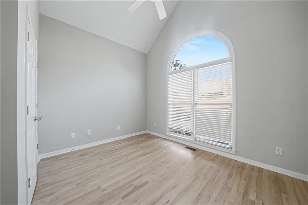 195 Brightmore Way Alpharetta, GA 30005 - Photo 13 of 30 an empty room with wooden floor and windows