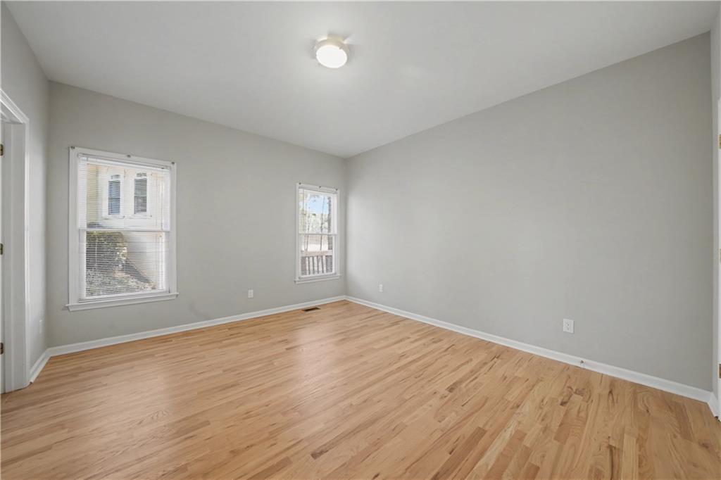 195 Brightmore Way Alpharetta, GA 30005 - Photo 14 of 30 an empty room with wooden floor and windows