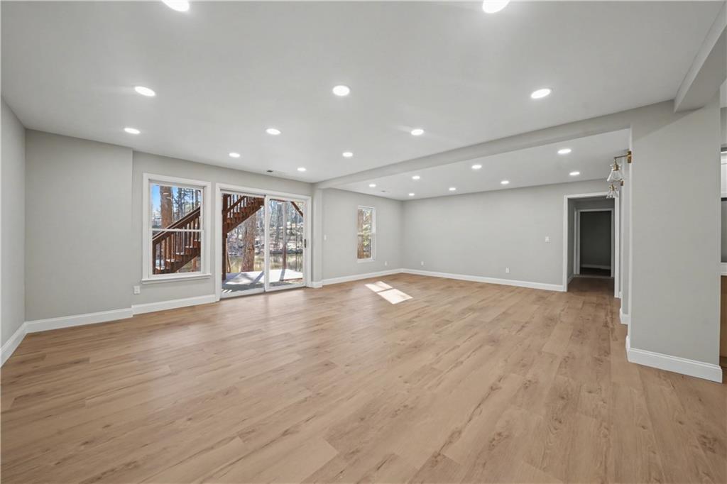 195 Brightmore Way Alpharetta, GA 30005 - Photo 17 of 30 a view of an empty room with wooden floor and window