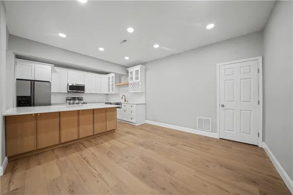 a kitchen with stainless steel appliances granite countertop a stove a sink and a refrigerator