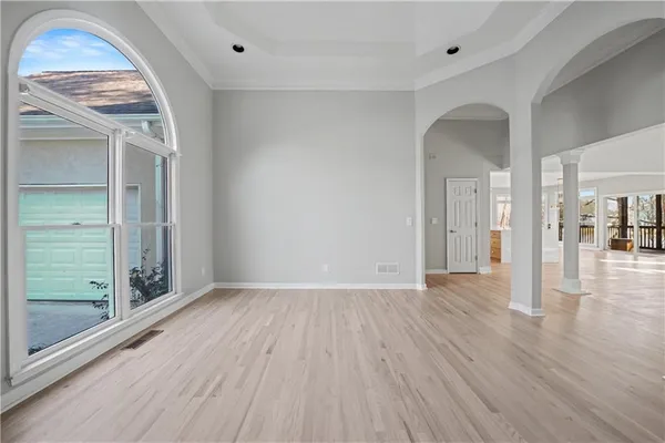 wooden floor in an empty room with a window