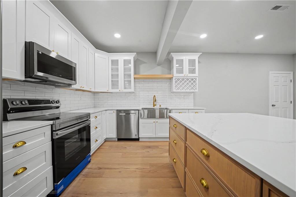 195 Brightmore Way Alpharetta, GA 30005 - Photo 21 of 30 a kitchen with a sink stove and microwave