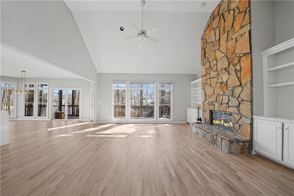 195 Brightmore Way Alpharetta, GA 30005 - Photo 3 of 30 a view of an empty room with wooden floor and a window
