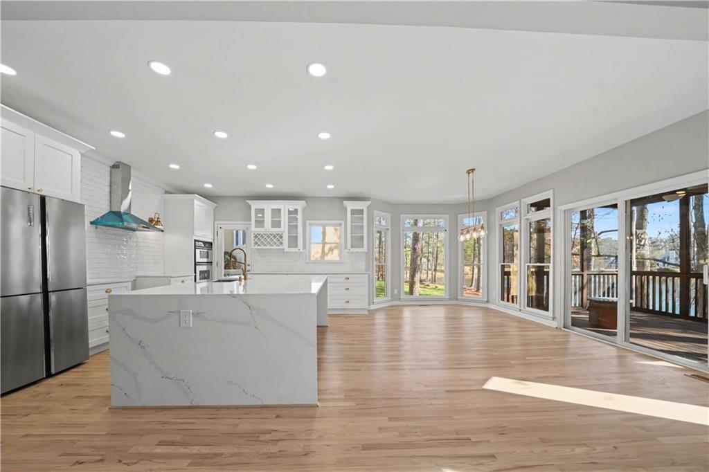 195 Brightmore Way Alpharetta, GA 30005 - Photo 4 of 30 a large white kitchen with large windows and refrigerator