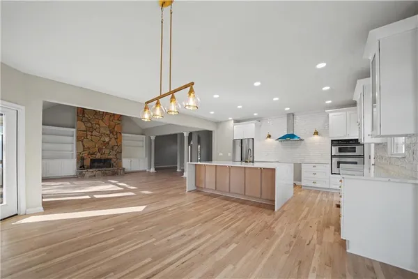 a view of kitchen with cabinets and wooden floor