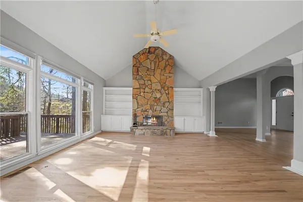 a view of empty room with window and hardwood floor