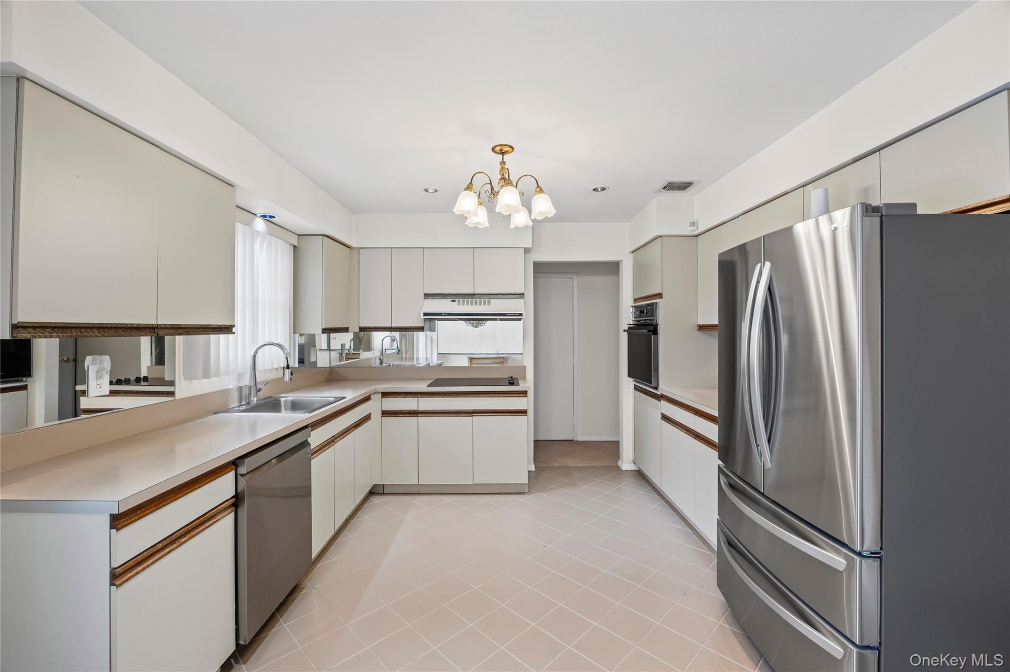 6 Hillview Court Commack, NY 11725 - Photo 18 of 43 a kitchen with stainless steel appliances a refrigerator sink and cabinets