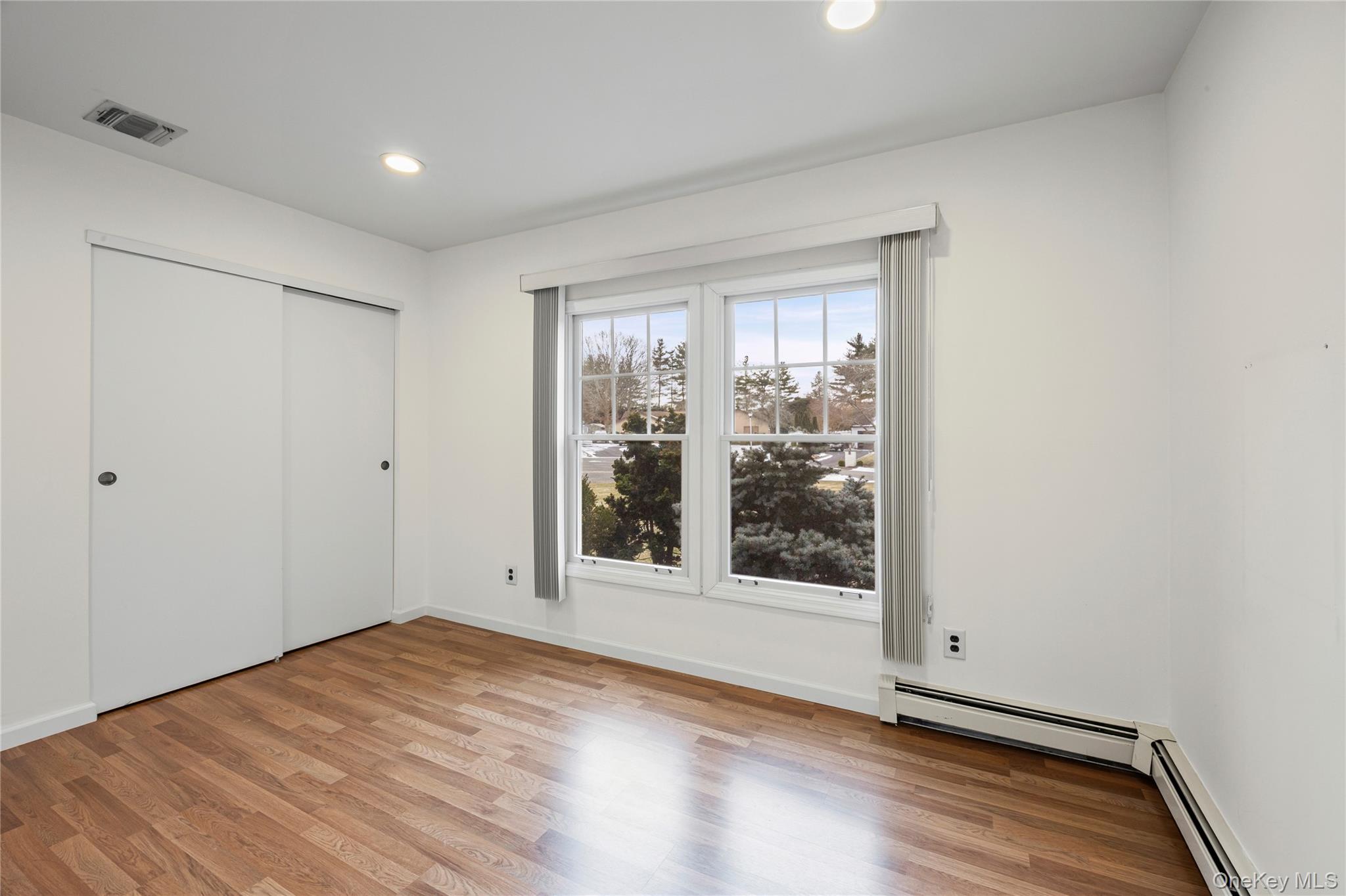 6 Hillview Court Commack, NY 11725 - Photo 23 of 43 a view of a room with wooden floor and window