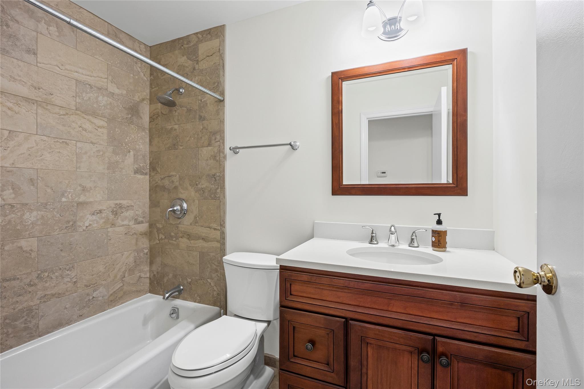 6 Hillview Court Commack, NY 11725 - Photo 24 of 43 a bathroom with a sink a toilet and shower