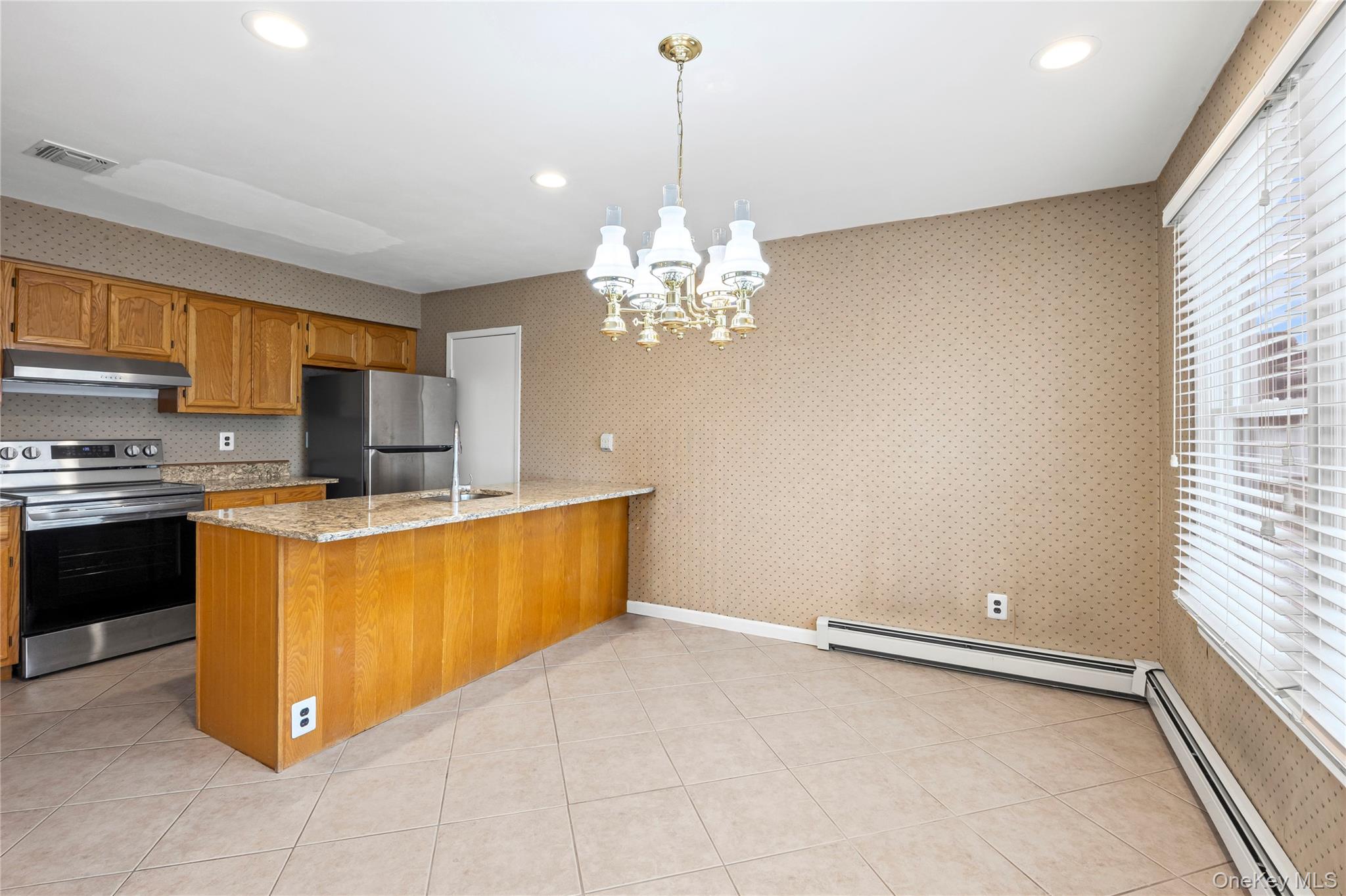 6 Hillview Court Commack, NY 11725 - Photo 29 of 43 a kitchen with stainless steel appliances granite countertop a stove a sink and a refrigerator