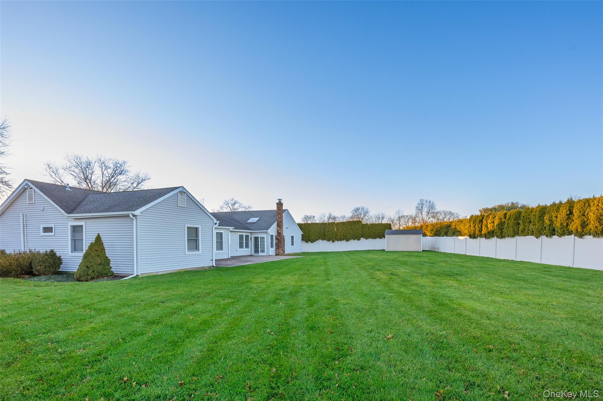 6 Hillview Court Commack, NY 11725 - Photo 38 of 43 a view of a house with a yard and a sitting area