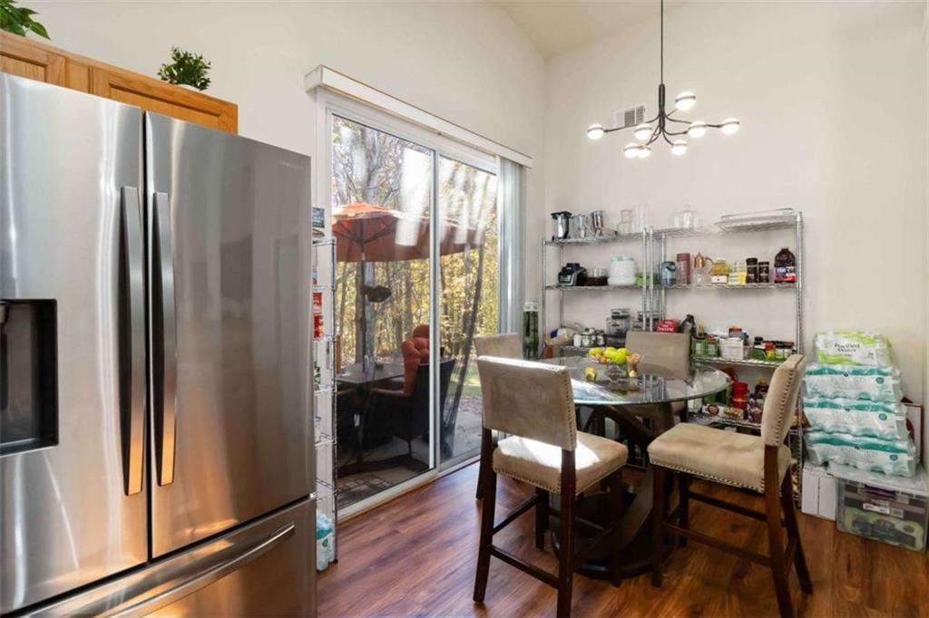 782 Jasperson Court Fairburn, GA 30213 - Photo 11 of 30 a dining room with furniture a chandelier and wooden floor