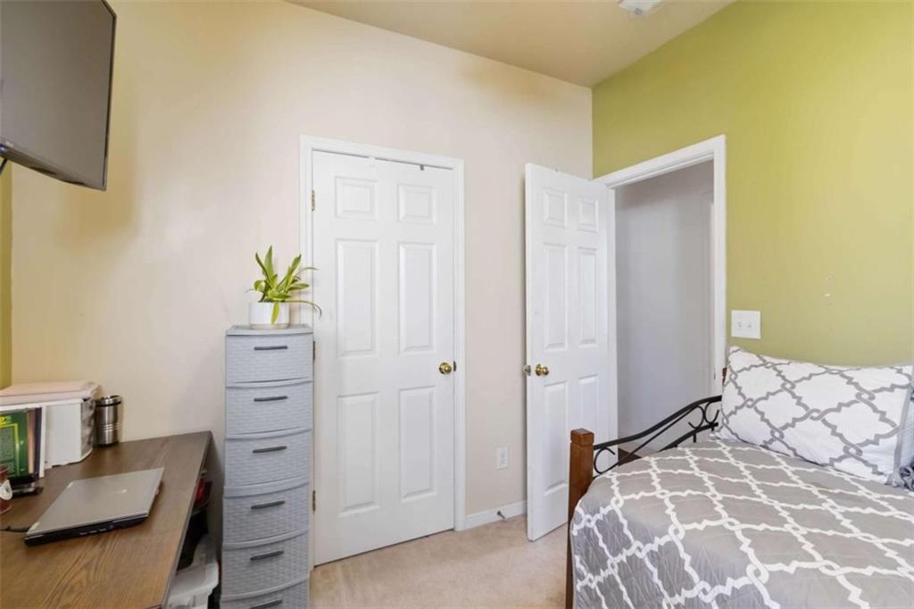 782 Jasperson Court Fairburn, GA 30213 - Photo 13 of 30 a bedroom with a bed and a sink