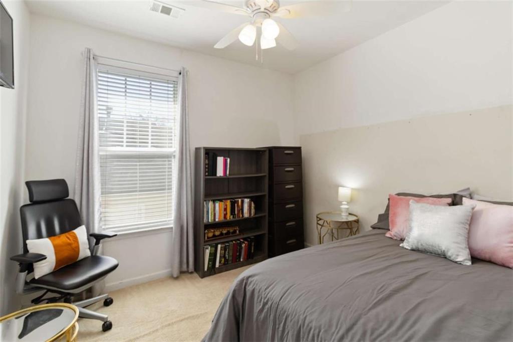 782 Jasperson Court Fairburn, GA 30213 - Photo 14 of 30 a bedroom with a bed and chair