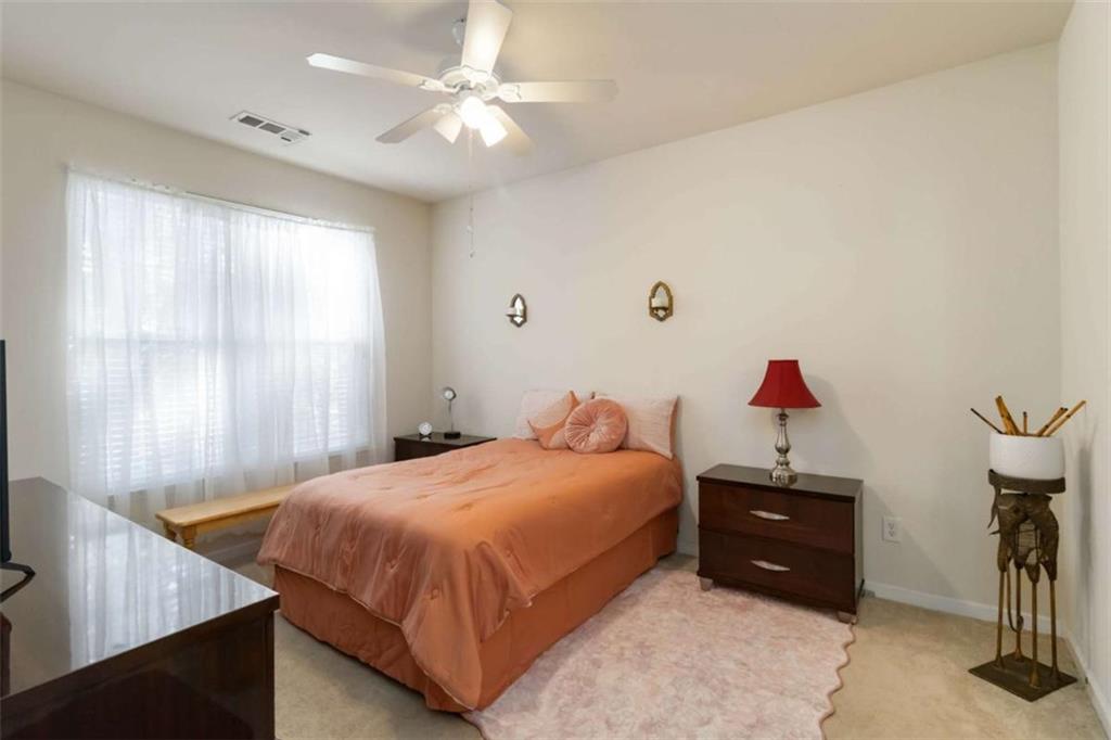 782 Jasperson Court Fairburn, GA 30213 - Photo 16 of 30 a bedroom with a bed and a chandelier