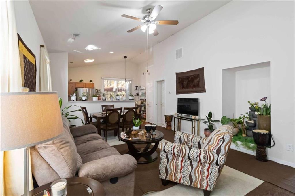 782 Jasperson Court Fairburn, GA 30213 - Photo 6 of 30 a living room with furniture kitchen view and a chandelier