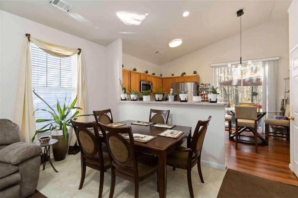 782 Jasperson Court Fairburn, GA 30213 - Photo 7 of 30 a view of a dining room and livingroom with furniture wooden floor a chandelier