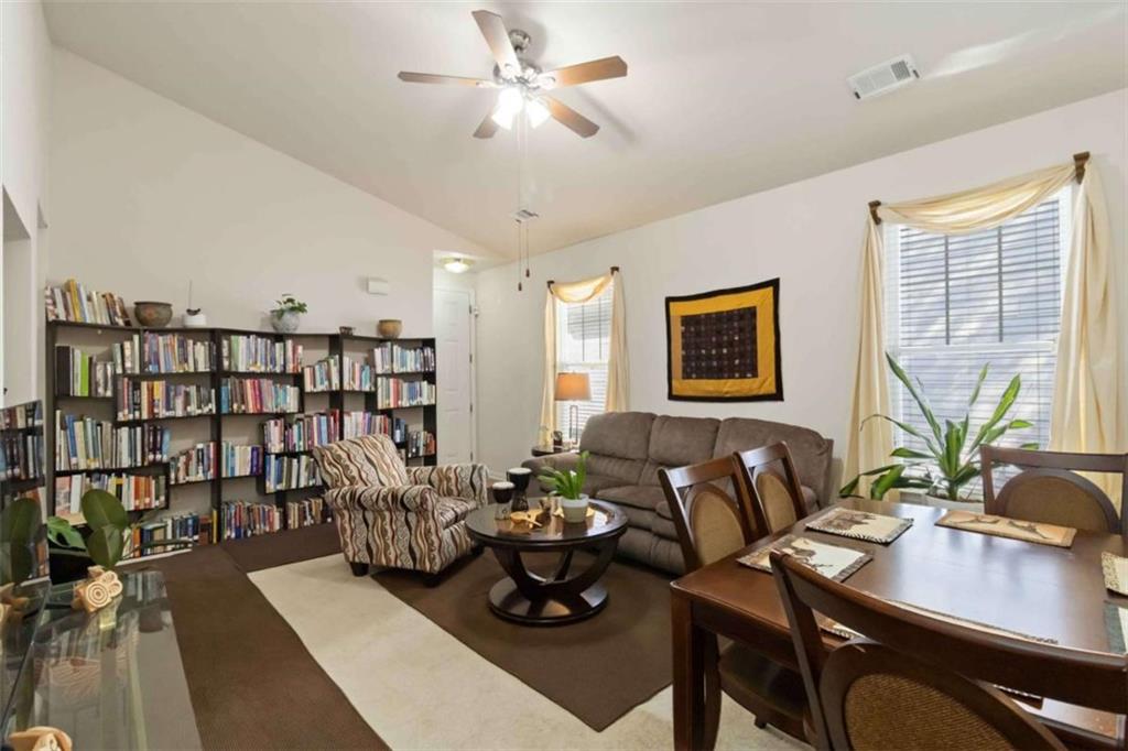 782 Jasperson Court Fairburn, GA 30213 - Photo 8 of 30 a living room with furniture potted plant and a bookshelf