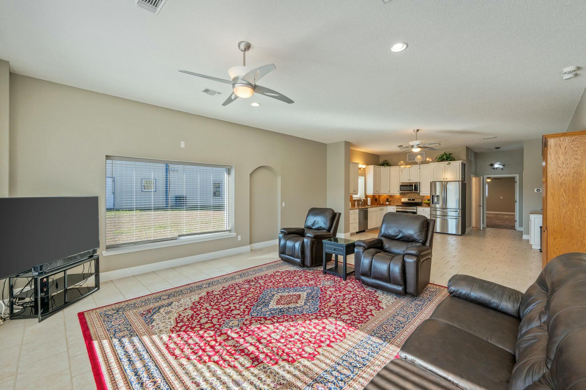 1476 Vinson Ray Road Baker, FL 32531 - Photo 27 of 41 a living room with furniture rug and wooden floor