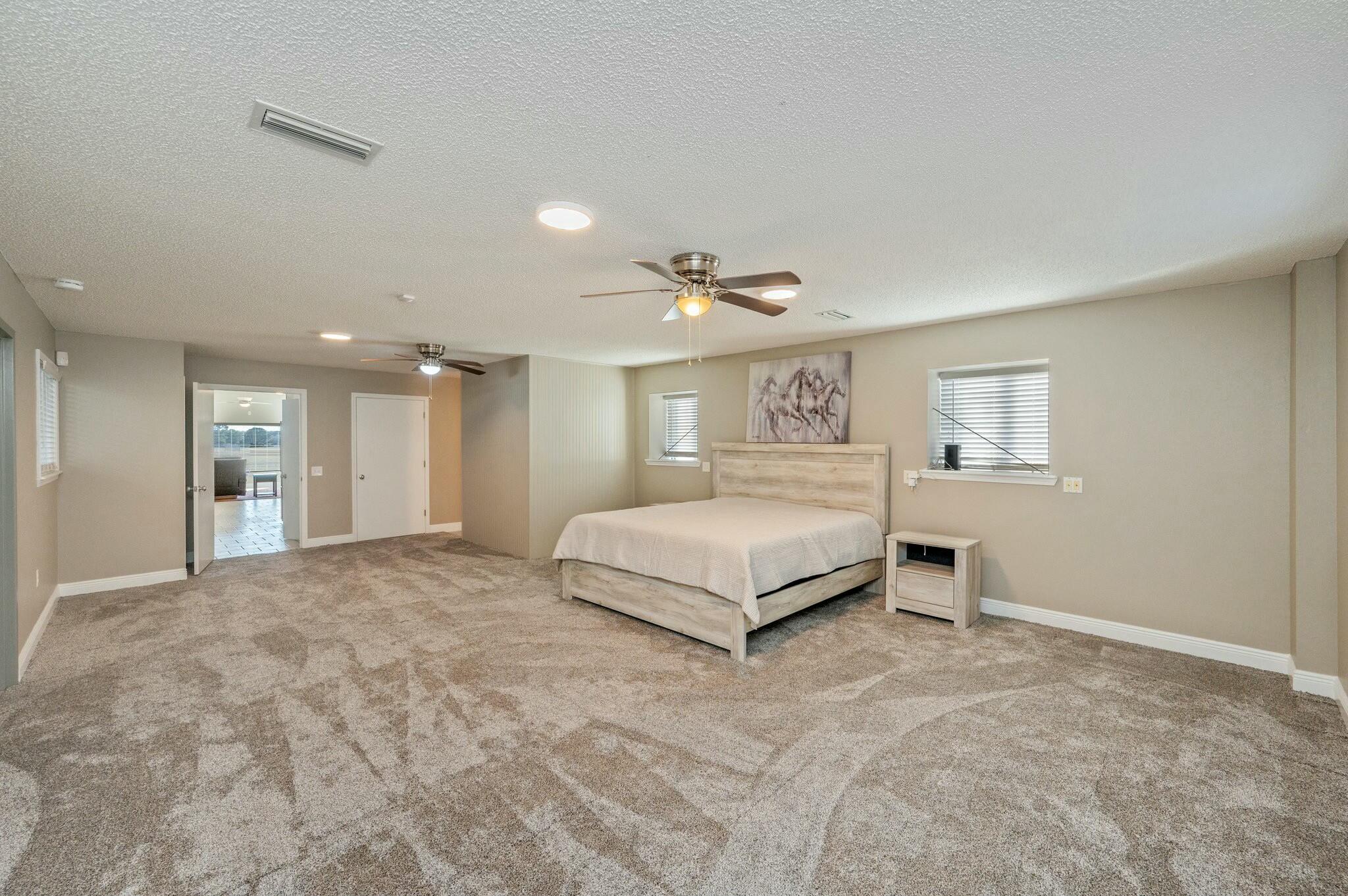 1476 Vinson Ray Road Baker, FL 32531 - Photo 29 of 41 a spacious bedroom with a bed and a night stand
