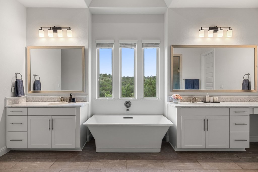 215 Lodestone Lane Austin, TX 78738 - Photo 8 of 40 Indulge in a tranquil retreat featuring dual vanities, a deep soaking tub, and picturesque outdoor views.