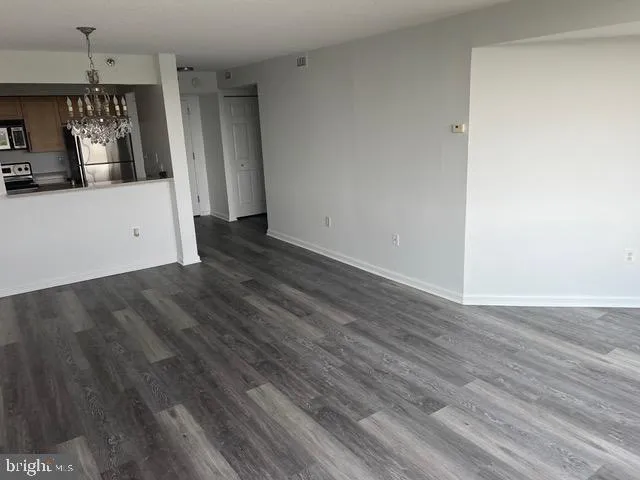 a view of a small space with wooden floor and a window