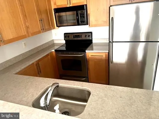 a kitchen with a refrigerator sink and microwave