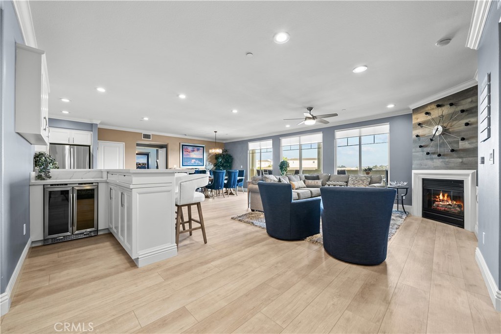 a living room with furniture a fireplace and a kitchen view