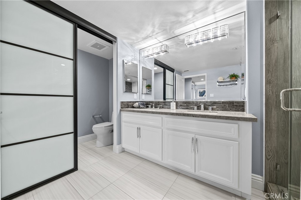 4344 Tradewinds Drive Oxnard, CA 93035 - Photo 21 of 57 a bathroom with a granite countertop sink mirror and a toilet