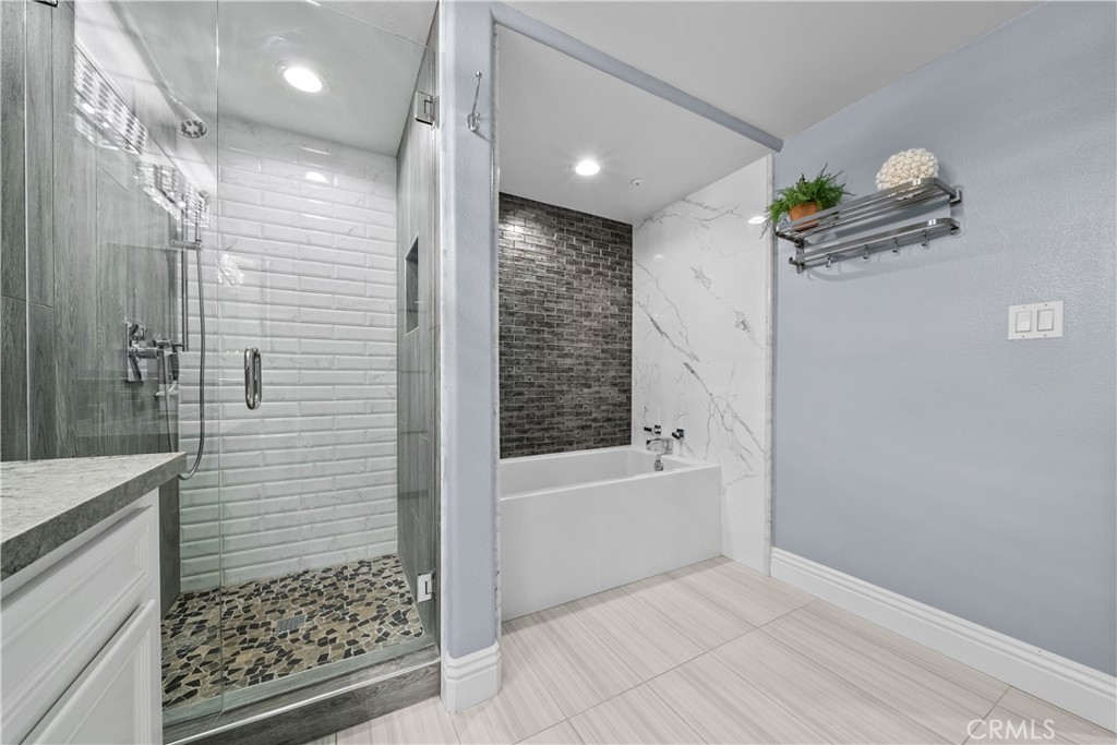 4344 Tradewinds Drive Oxnard, CA 93035 - Photo 22 of 57 a bathroom with a bathtub a shower and a sink