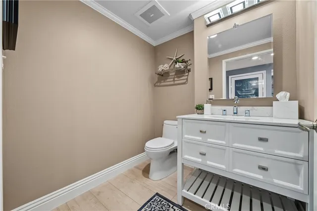 a bathroom with a sink toilet and mirror