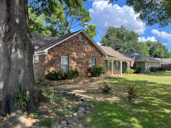 a front view of house with yard and green space