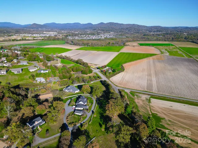 a view of a lush green hillside and houses