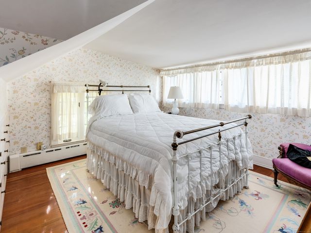 a view of an empty room with a window and front door
