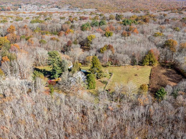 a view of a dry top of a field with lots of bushes