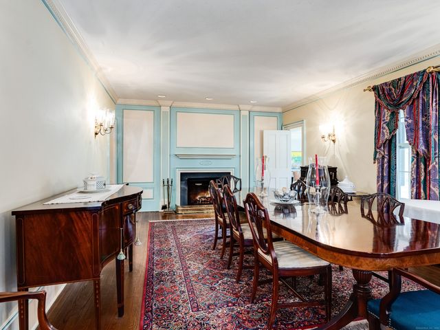 a dining room with furniture a rug and wooden floor