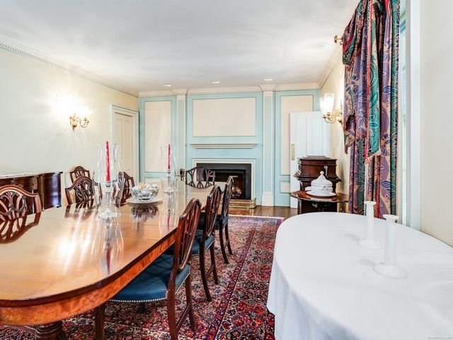 a dining room with furniture and wooden floor