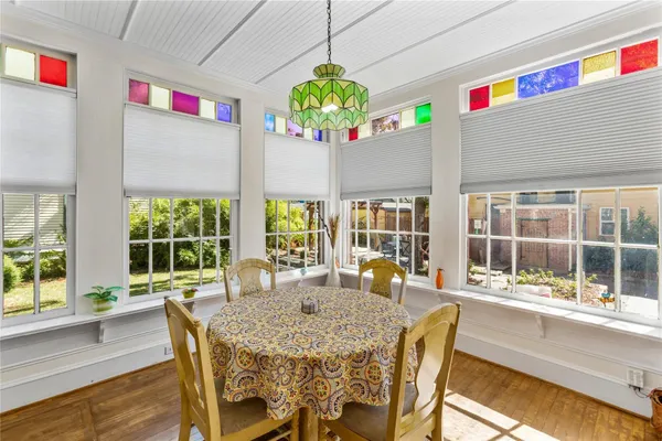 a view of a dining room with furniture a chandelier and wooden floor