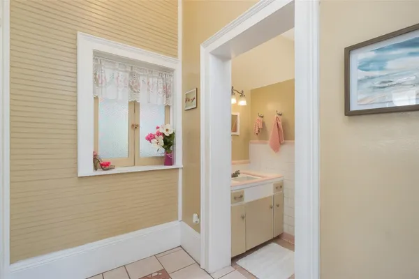 a bathroom with a sink vanity and tub