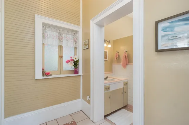 a bathroom with a sink vanity and tub