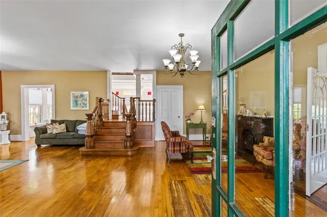 a living room with fireplace furniture and a chandelier