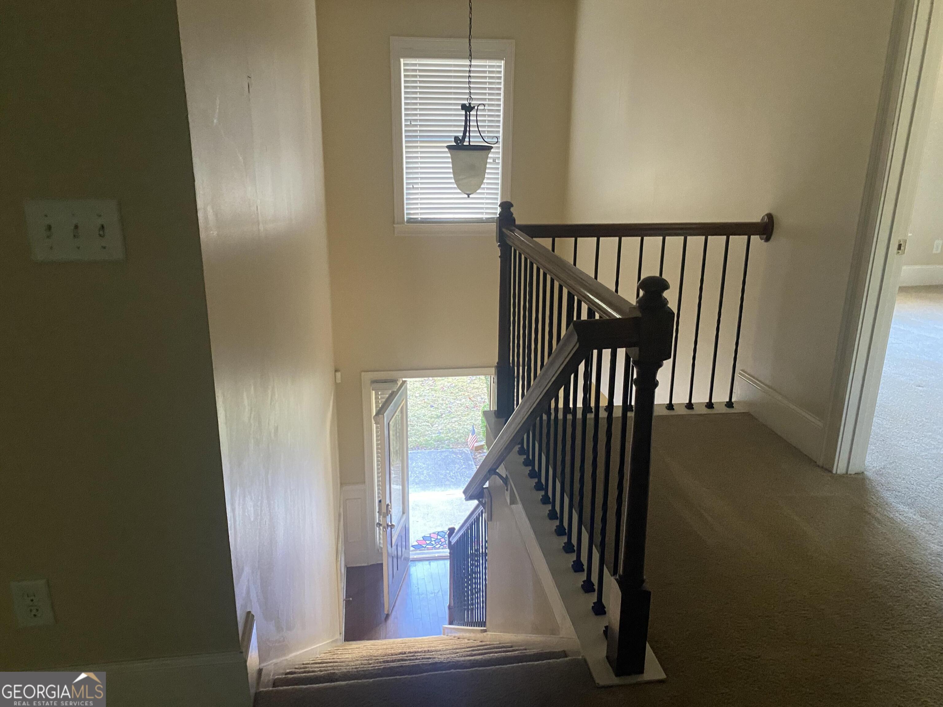 5441 Stirrup Way Powder Springs, GA 30127 - Photo 3 of 17 a view of staircase with wooden floor and a window